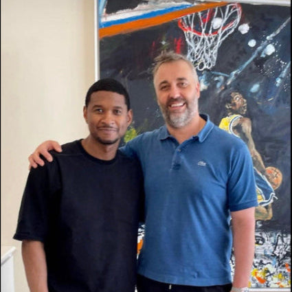 Usher and Fabrice Gautier standing together in front of the infamous Kobe Bryant Quigley painting.